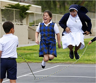 students playing jump rope with a sister