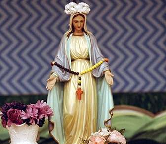 Mary statue holding a rosary