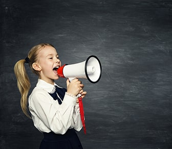 child in uniform with megaphone