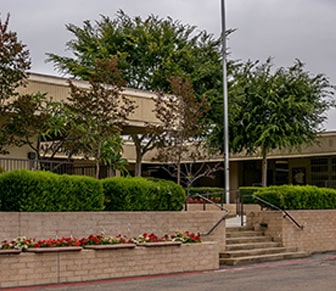 Nazareth School building with flag pole in front