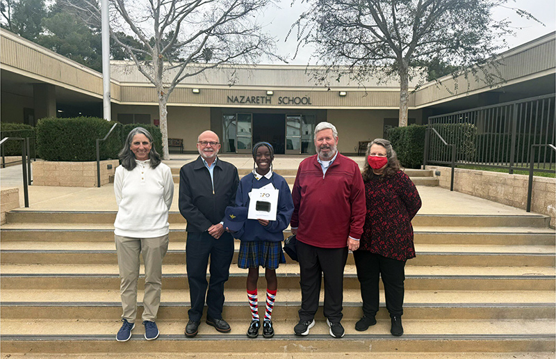 Spelling Bee winner, Danielle, with other school representative outside school building