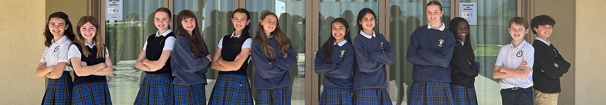 Four happy students welcoming you to Nazareth School