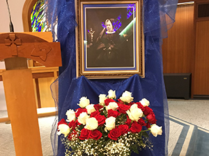 Close up of church altar with roses under portrait