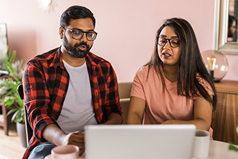 concerned parents looking at computer