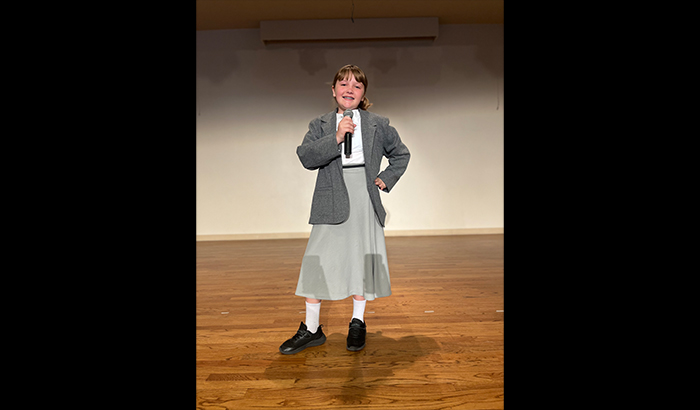 Actress on stage holding a microphone