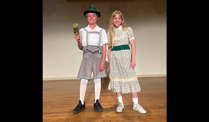 Two actors in costume on stage