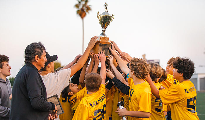 Team and coaches holding up trophy