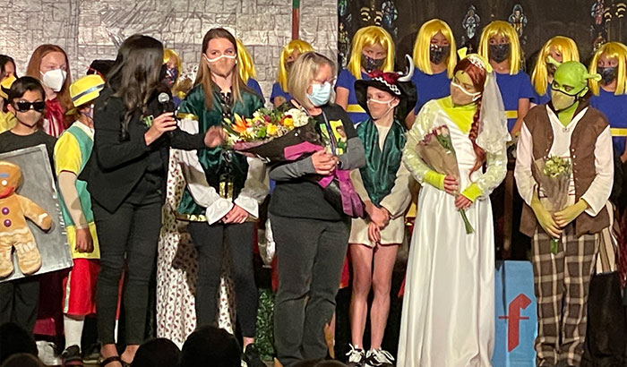 Shrek The Musical cast on stage receiving flowers