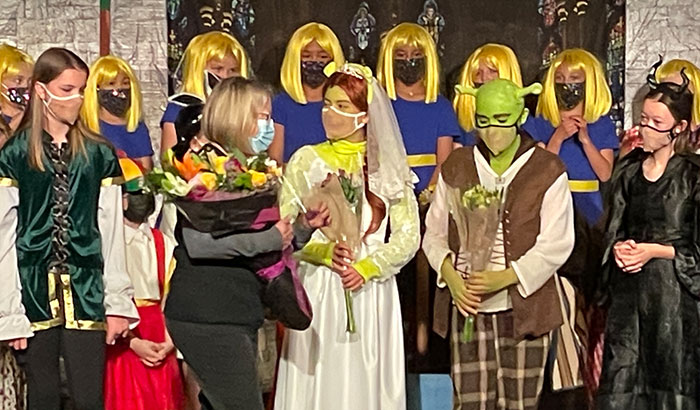Shrek The Musical cast on stage smiling
