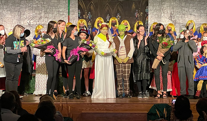 Shrek The Musical cast on stage reading out awards